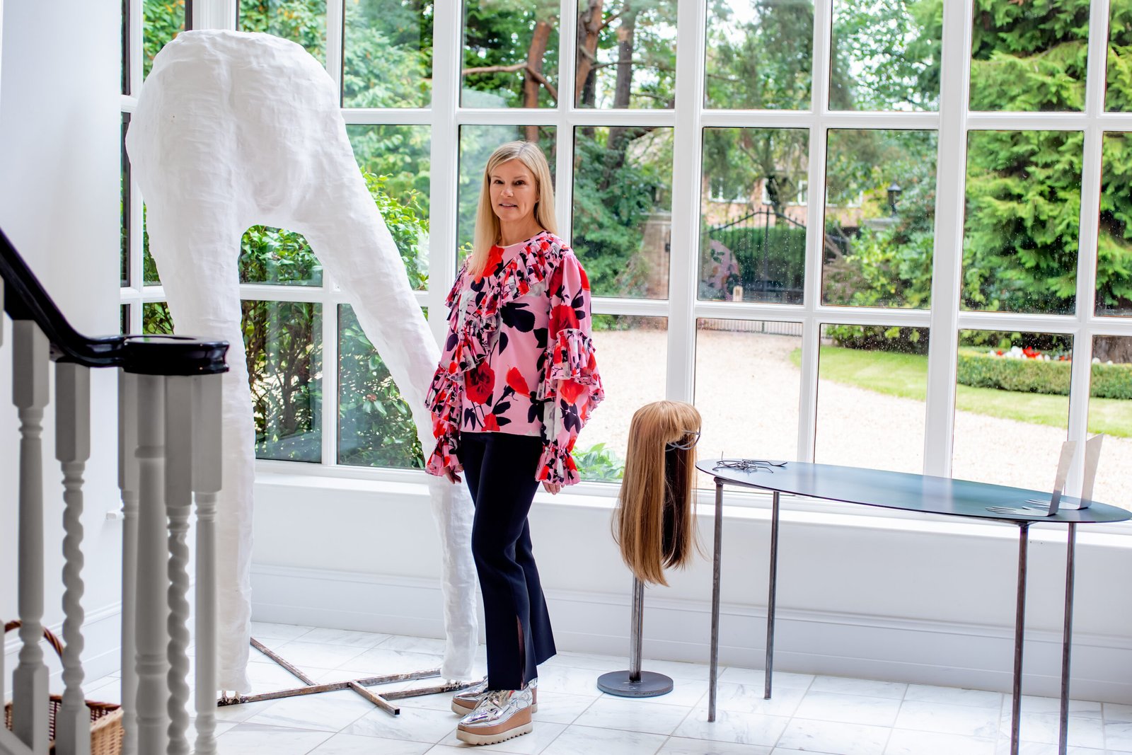 Portrait of Marcelle Joseph at her home with artworks by Rebecca Ackroyd and Kira Freije