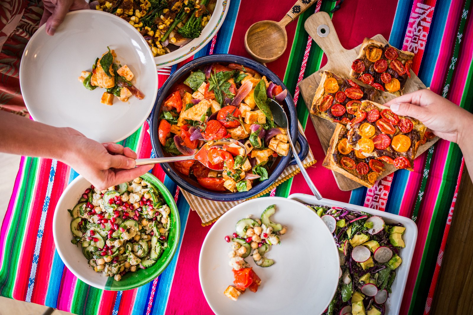 sharing table of vibrant salads