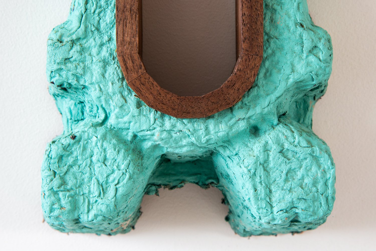 Detail of Jon Kipps sculpture made with wood and green paper pulp